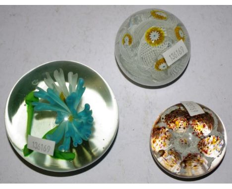 Three various vintage art glass paperweights to include a  latticino and millefiori Murano glass, a floral centered, and one 