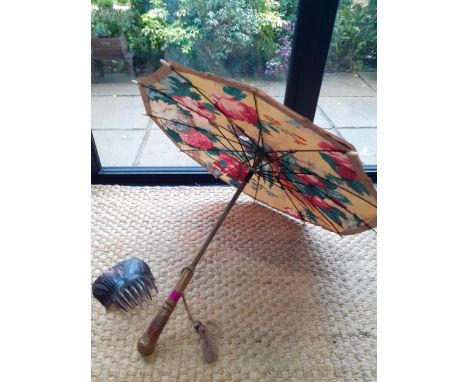 An early 20th Century painted silk parasol A/F depicting a parrot, flowers and fruit on a yellow background having a painted 