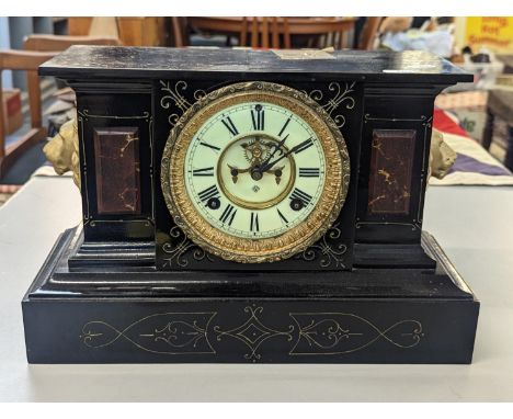 A late 19th Century American Ansonia slate and marble mantle clock having a white enamel dial with Roman numerals and exposed