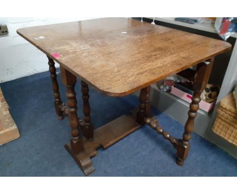 A small oak drop leaf table with bobbin support, 65cmHigh x 83cmWide (extended) x 71cm. Location:BWR 