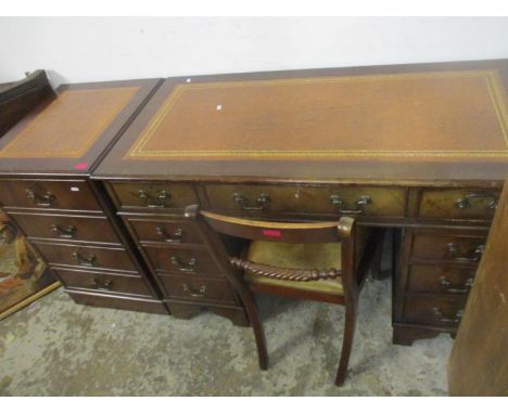 A reproduction mahogany twin pedestal desk, inset red leather tooled top with moulded edge, central long drawer flanked by tw