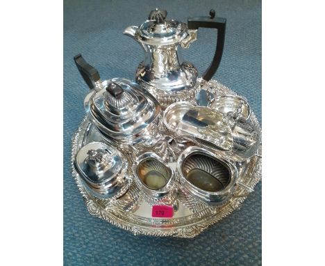 A Mappin &amp; Webb silver plated, circular tray with Rococo detail to the rim, together with a five piece silver plated teas