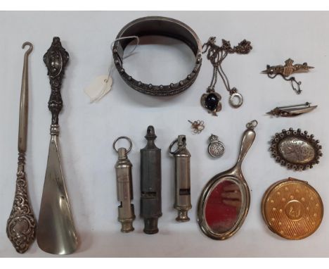 A silver bangle 37.4g, a silver handled button hook, 3 vintage whistles to include a Girl Guide example, a gold tone compact,