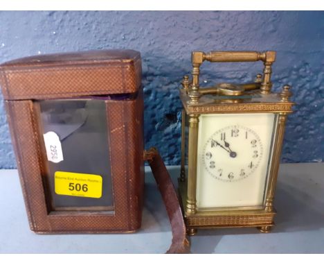 A late 19th century brass cased carriage clock in a fitted travel case together with an early 20th century postman's alarm cl