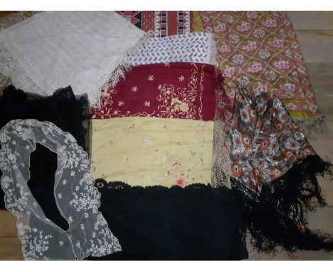 A group of lace, silk shawls and mixed textiles to include a mid 20th Century machine made cream lace shawl with tassels, an 