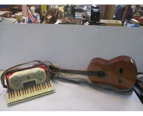Musical instruments to include a Kimgara acoustic guitar together with a Sonola accordion model R342.Location:1:3 
