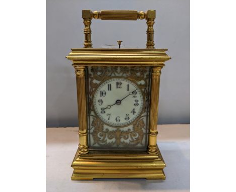 A late 19th century brass cased repeater carriage clock having reeded columns and pierced, gilt floral dial, 19h A/F 