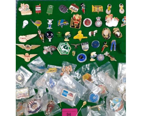 A collection of late 20th Century enamelled and metal badges to include Golly, Labour Party, Army cadet, TWA wings and Smurf 