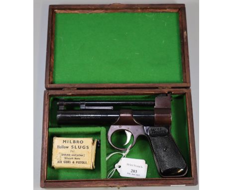 The Webley Junior .177 air pistol with blued action and black grips marked 'Webley' in fitted mahogany box with original card