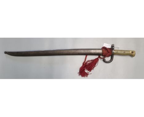 19th century French brass hilted sword bayonet with fullered slightly curved blade and metal scabbard with red braid.  Overal
