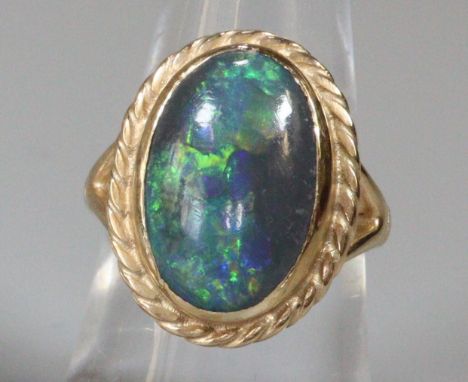 9ct gold large oval opal dress ring. Size M. 7g approx. (B.P. 21% + VAT)  Dimensions of stone are: 1.8x1.0cm approx.