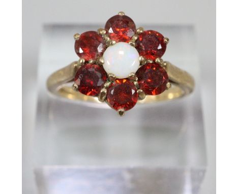 9ct gold red stone and opal flower head dress ring.  Size N1/2.  6.7g approx.  (B.P. 21% + VAT) 