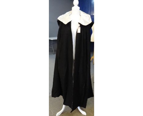 Vintage black woollen opera cloak with hood and 'Hagarty, Irish hand woven tweed, pure new wool' label and silky lining. (B.P