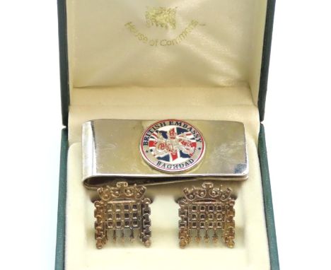 A pair of white metal Houses of Parliament portcullis cufflinks twinned with a British Embassy Baghdad white metal money clip