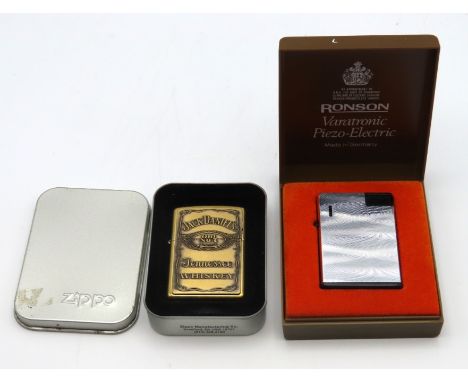 A Zippo Jack Daniels lighter twinned with a Ronson Vara-Tronic Pieza Electric lighter