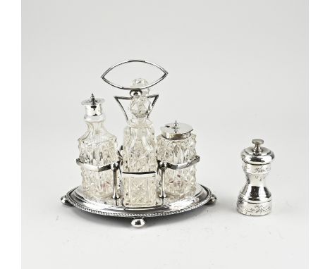 Menage set and a pepper mill, menage set with 4 crystal decanters, one with a silver neck and a plated sprinkle lid and one w