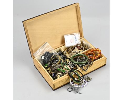 Wooden box with jewelry, including a jade bracelet, various ear studs, brooches, various necklaces and bracelets.