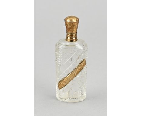 Odeur bottle with gold, 585/000, oval crystal model with various cutwork, equipped with a yellow gold element with engraving 