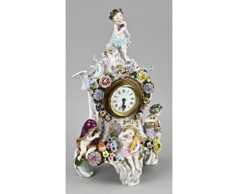 Antique German Sitzendorf porcelain mantel clock with figures, putti and floral decor. Circa 1890. Eight-day silent movement.