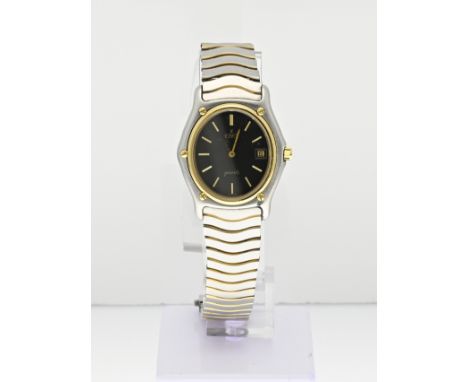 Ebel classic wave ladies watch, oval model with a steel and gold strap. The watch has a black decorated dial with a date indi