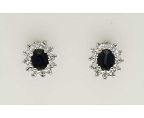 White gold stud earrings, 585/000, with sapphire and diamond. Stud earrings model Lady Di, with an oval faceted blue sapphire