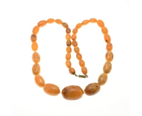 Necklace of butterschotch amber beads, oval model, varying in size. Ã¸ 10-21 mm. length 65 cm. approximately 55 grams. In rea