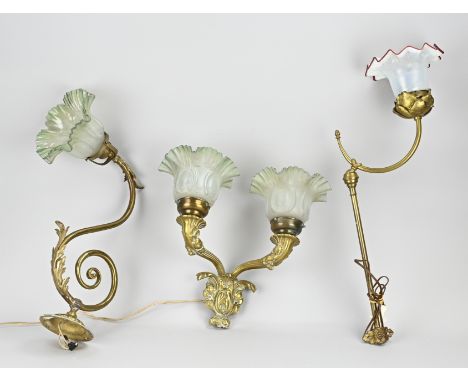 Three antique brass wall lamps with glass shades. First half 20th century. Size: 35 - 55 cm. In good condition.