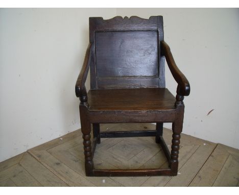 18th C oak Wainscot style chair with panelled back and solid seat on bobbin turned supports 