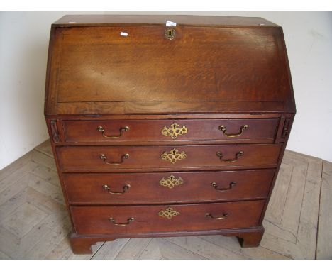 19th C oak bureau with fall front revealing fitted interior above four drawers on raised bracket feet (width 92cm) 