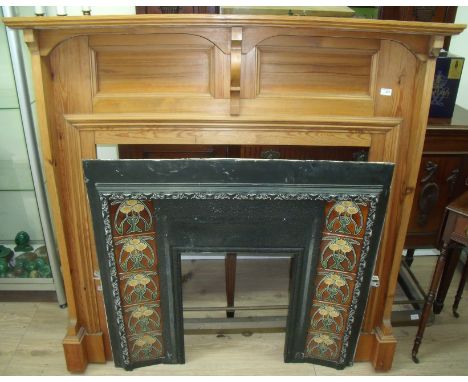 Pine fire surround and mantel piece with cast metal fire insert with Art Nouveau tiled sides (overall width 140cm)