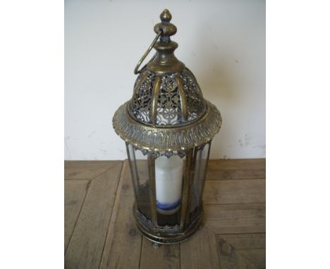 Floor standing pierced metalwork and glazed lantern with altar candle (approx. 55cm high)