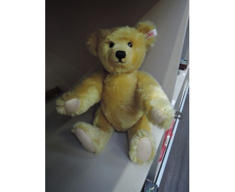 A modern Steiff golden mohair teddy bear having jointed body and growling mechanism, length 17'