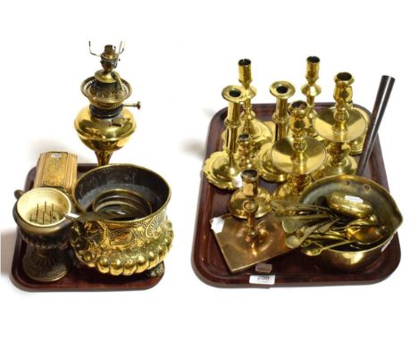 A quantity of Georgian and mostly Victorian brass including four pairs of candle sticks, various spoons, a planter, an oil la