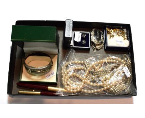 A small group of costume necklaces; a silver bangle; two Parker pens; a silver scotch decanter label and a matching label for