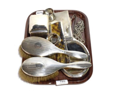 A collection of silver of various dates to include, sugar tongs, Albert watch chain, napkin rings and dressing set