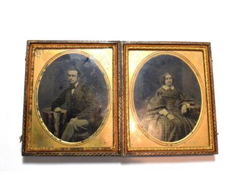 A Victorian double daguerreotype portrait of a lady and gentleman in a fitted leather case, stamped Jackoletts Photographic S
