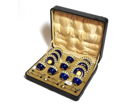 A cased Royal Worcester coffee set, including six silver spoons      one handle loose but present 