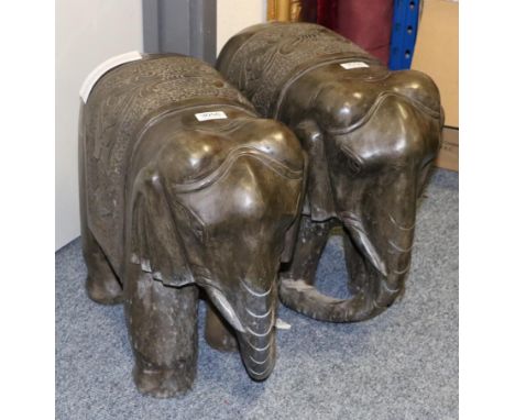 A Pair of Indian Carved Stone Figures of Elephants, modern, standing on four square from legs with foliate carved saddle clot