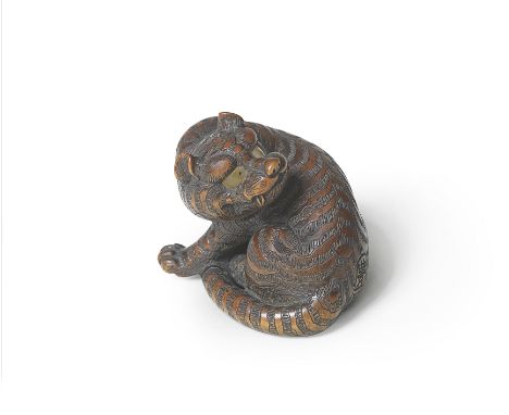 A WOOD NETSUKE OF A TIGERBy Naito Toyomasa (1773-1856), Tanba Province, early/mid-19th centuryThe sabre-toothed tiger seated,