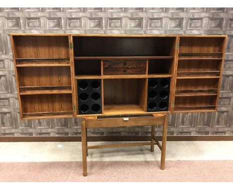 ROSEWOOD OBLONG DRINKS CABINET By Robert Heritage for Archie Shine, the fitted interior of open shelves, small drawers and bo