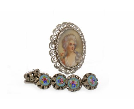 EARLY 20TH CENTURY PORTRAIT BROOCHthe central oval section painted to depict a woman in a pink dress, in an ornate threaded m