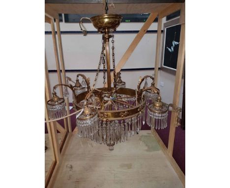 IMPRESSIVE GILDED BRASS AND CRYSTAL CHANDELIER the central column suspending a broad ring around light sconces, the curved ac