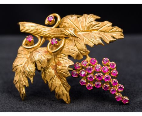 An 18 ct gold ruby set broochWorked as a fruiting vine.  4 cm wide.    CONDITION REPORTS:  Generally in good condition, expec