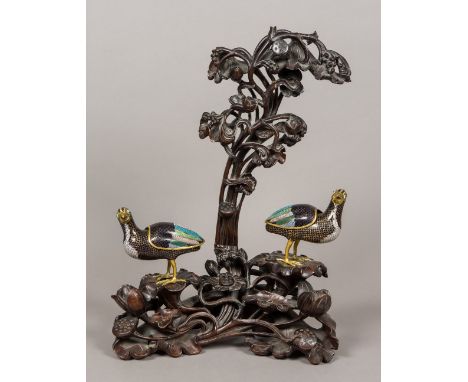 A pair of 19th century Chinese cloisonne censersEach formed as a bird, with removable cover, standing on an ornately carved a