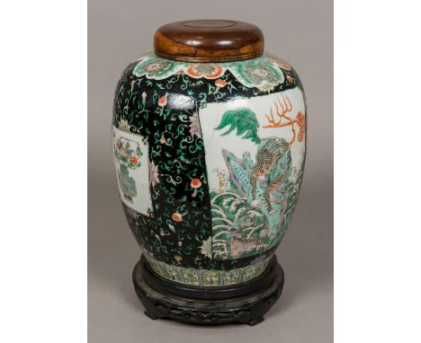 A 19th century famille verte ginger jarDecorated with a panel of mythical beasts, with further bird and floral filled panels 
