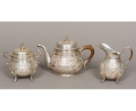 A Persian silver three piece tea set, with 84 purity mark and Farsi script hallmarkComprising: teapot, cream jug and lidded s