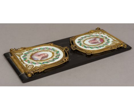 A 19th century ormolu and Sevres style painted porcelain mounted book slideEach end panel painted with female portrait bust a