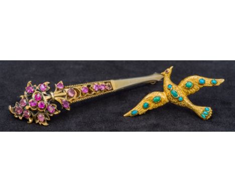 An antique turquoise set high carat gold broochWorked as a bird in flight with hand engraved decoration and a ruby set eye; t