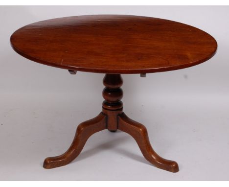 A George III mahogany supper table, the circular tilt-top on a turned column and tripod base, dia. 111cm, h.73cm 