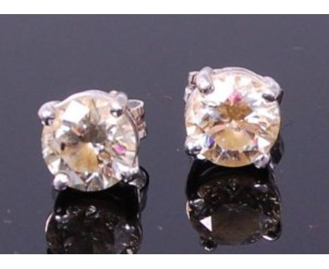 A pair of 18ct white gold and diamond set ear studs, the four claw set brilliants each weighing approx 0.95ct, we would asses